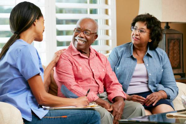 male and female caregiver with older man